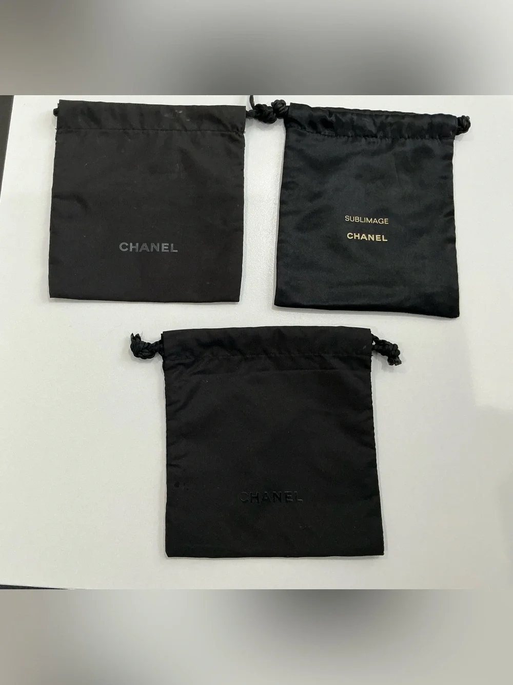 CHANEL lot of 3 black drawstring pouches dust bags, Sublimage beauty storage.